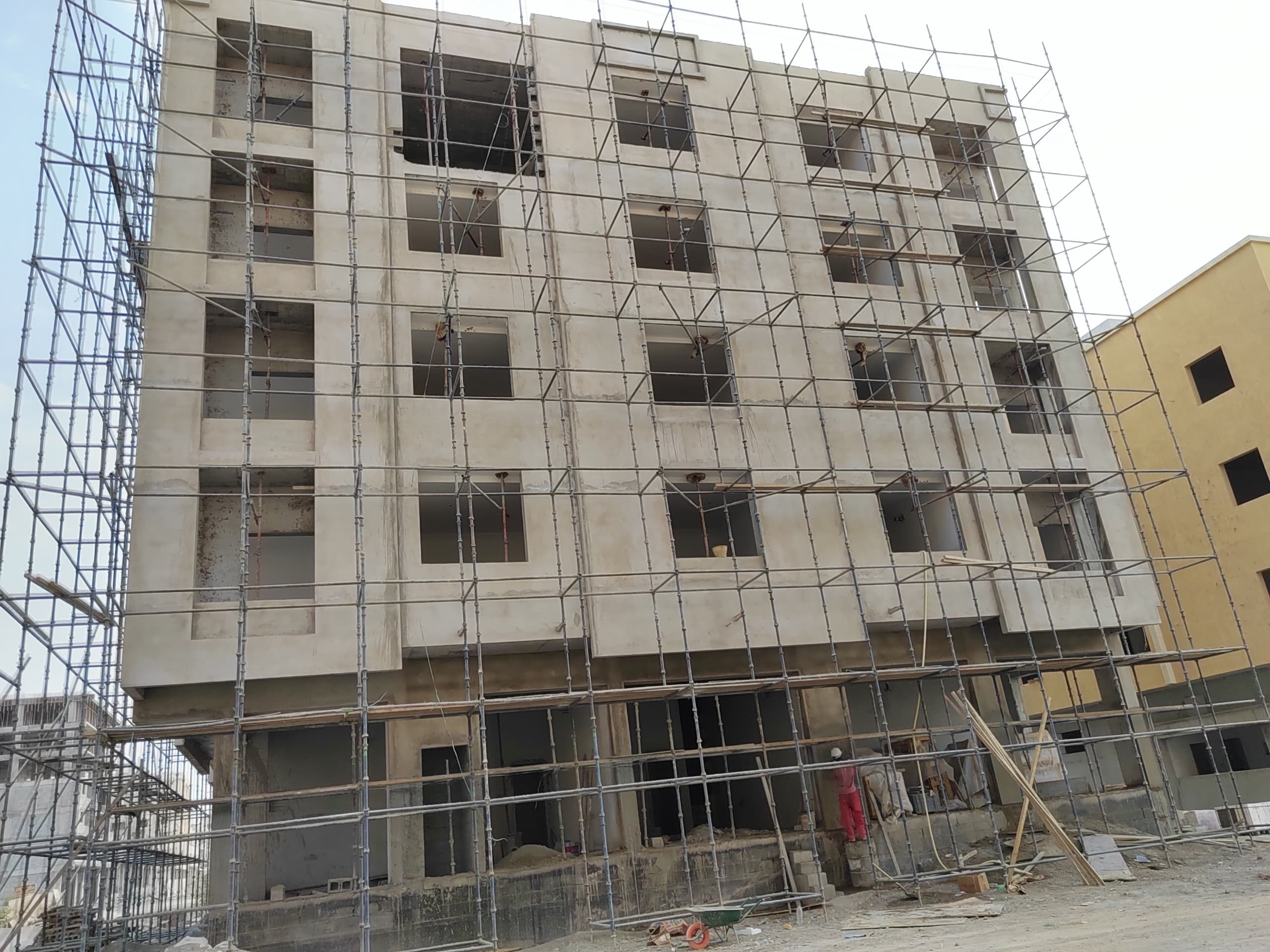 A sixteen-unit two-bedroom flat building with ground-floor offices — view 1